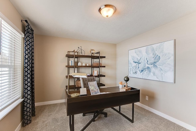 carpeted home office with a textured ceiling