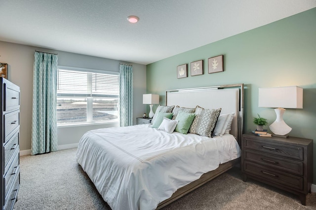 bedroom featuring a textured ceiling and light carpet