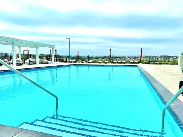 view of pool with a patio and a pergola