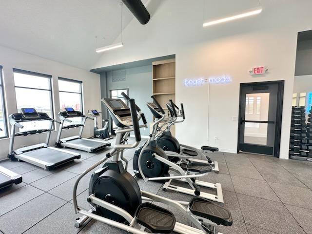 gym with a towering ceiling