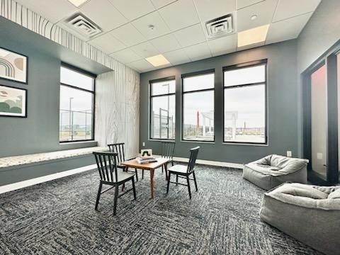 interior space featuring a drop ceiling and carpet flooring