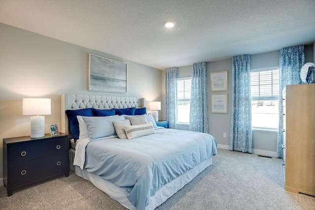 carpeted bedroom featuring a textured ceiling