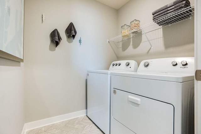 laundry room with light tile patterned floors and washer and clothes dryer