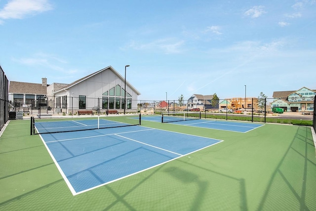 view of tennis court featuring basketball court