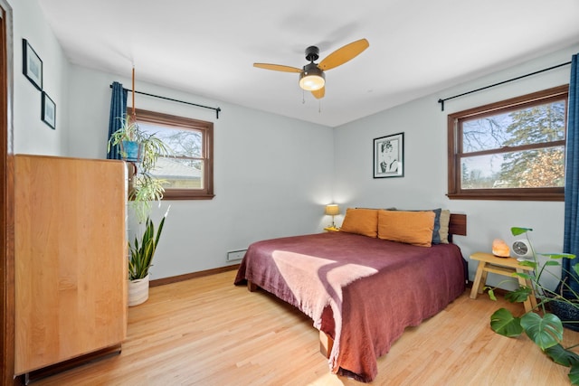625 5th Ave S, Hopkins, MN 55343 - bedroom with multiple windows, wood finished floors, and ceiling fan