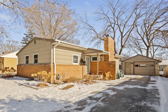 625 5th Ave S, Hopkins, MN 55343 - view of front of house featuring brick siding, a garage, a chimney, and an outbuilding