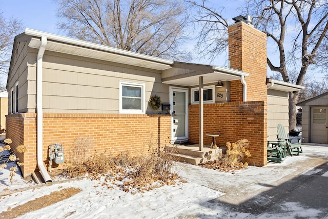 625 5th Ave S, Hopkins, MN 55343 - view of front of property with brick siding and a chimney
