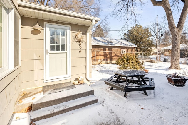 625 5th Ave S, Hopkins, MN 55343 - snow covered property entrance with a patio