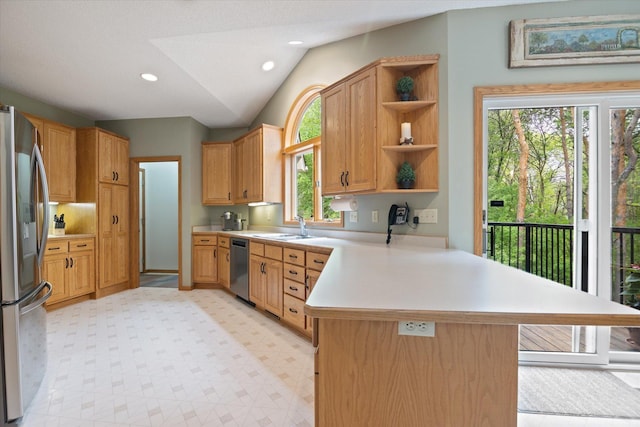 kitchen with plenty of natural light, kitchen peninsula, stainless steel appliances, and light tile flooring