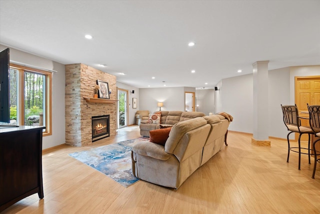 living room featuring a fireplace and light hardwood / wood-style floors