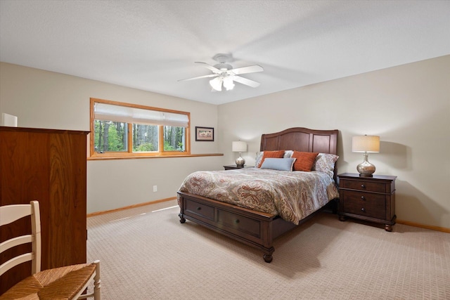 bedroom with ceiling fan and light colored carpet