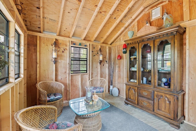 sitting room featuring lofted ceiling and light colored carpet