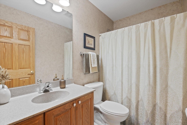 bathroom with toilet and vanity