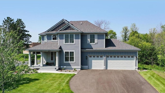 view of front of property with a front lawn and a garage