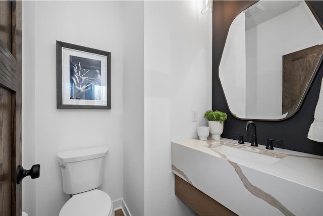 bathroom featuring toilet and sink