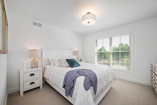 bedroom featuring light carpet