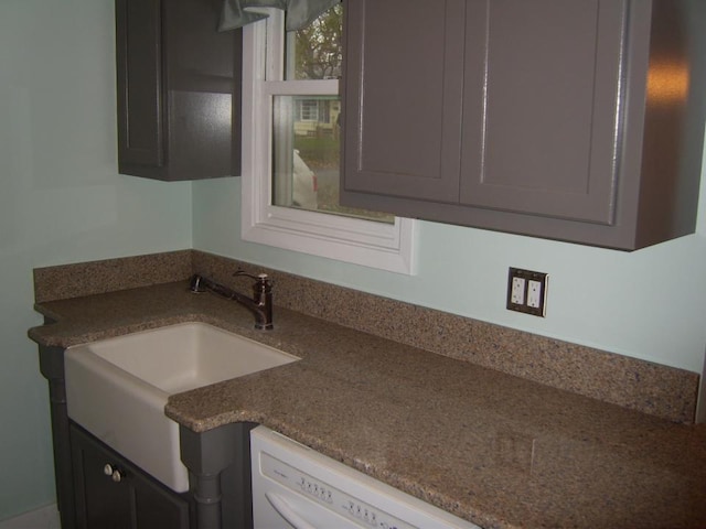 kitchen featuring dark stone countertops and sink