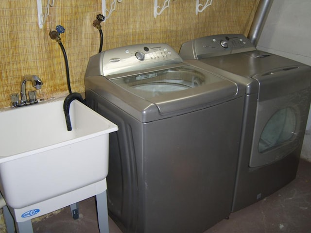 washroom featuring washer and clothes dryer and sink