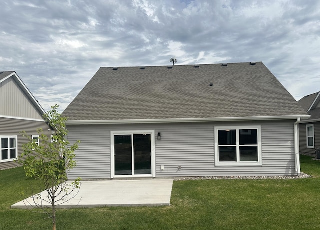 back of house with a patio area and a yard