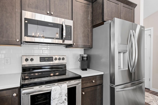 kitchen featuring decorative backsplash, appliances with stainless steel finishes, and dark brown cabinetry