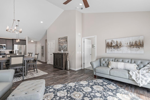 living room with high vaulted ceiling, dark hardwood / wood-style flooring, and ceiling fan with notable chandelier