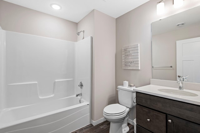 full bathroom featuring hardwood / wood-style flooring, tub / shower combination, toilet, and vanity