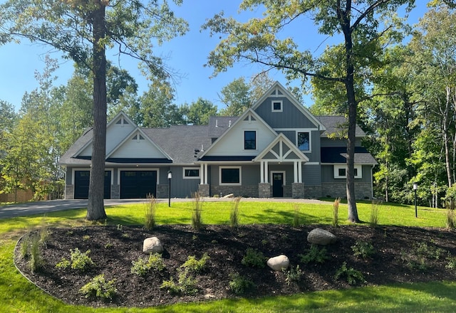 craftsman-style house featuring a front yard and a garage