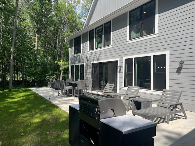 back of property with a patio area and a lawn