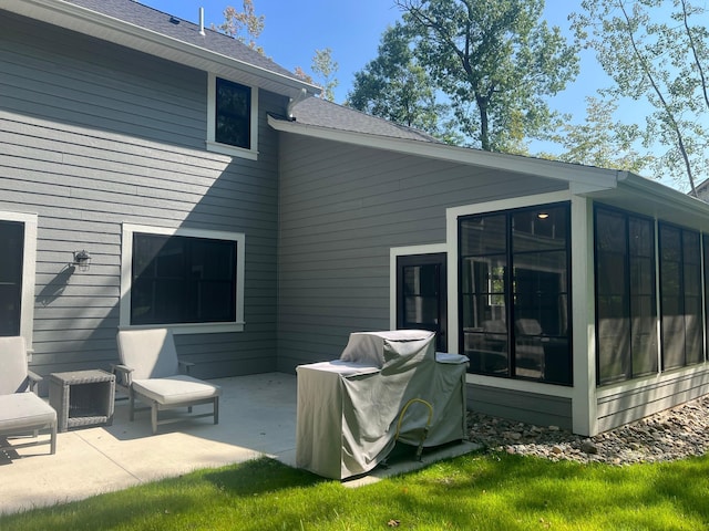 back of house featuring a sunroom and a patio area