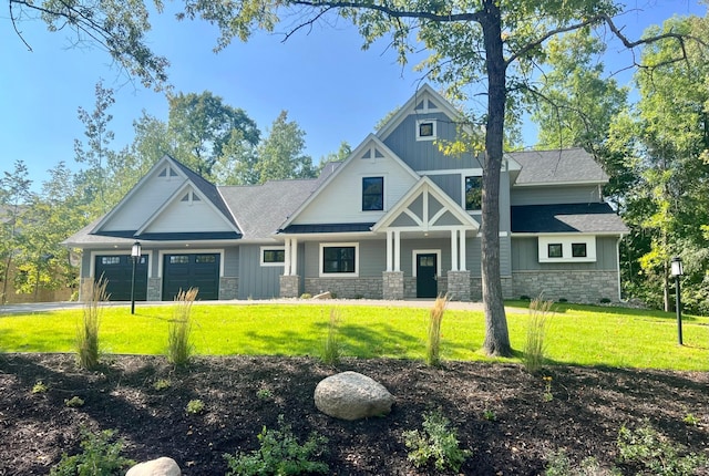 craftsman inspired home featuring a front lawn and a garage