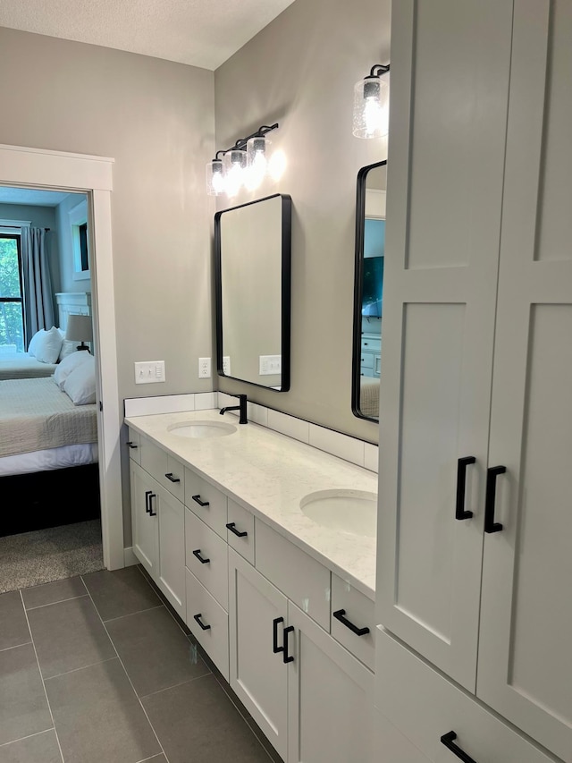 bathroom featuring tile flooring, double sink, and vanity with extensive cabinet space