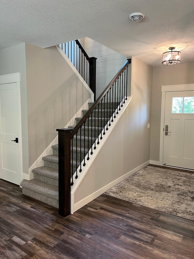 interior space with dark hardwood / wood-style floors and a textured ceiling