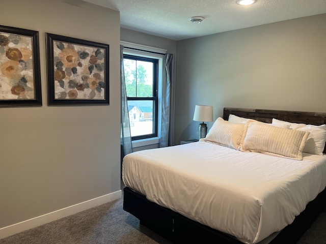 carpeted bedroom with a textured ceiling