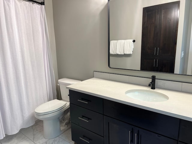 bathroom with tile flooring, vanity with extensive cabinet space, and toilet