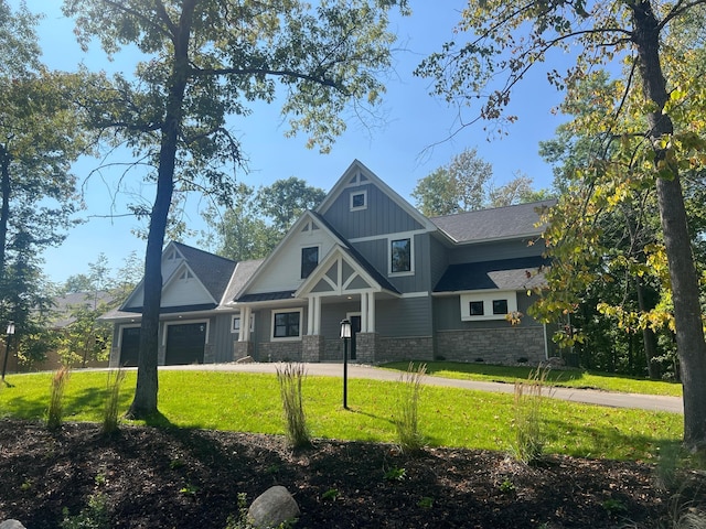 craftsman-style house featuring a front lawn and a garage