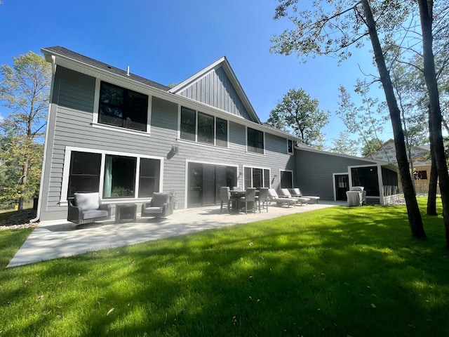 rear view of house with a yard and a patio