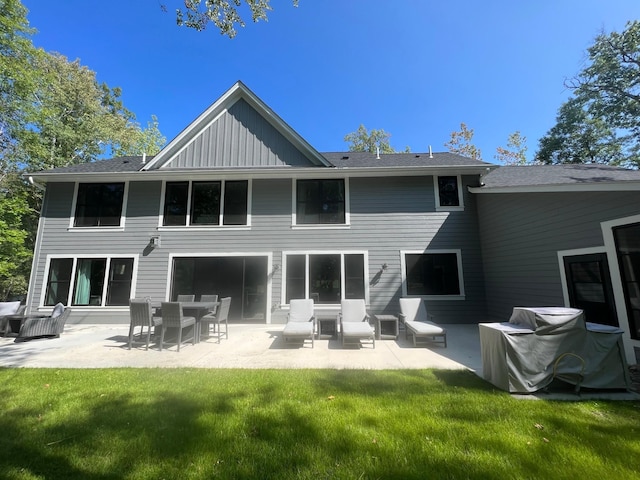 rear view of property featuring a patio and a yard