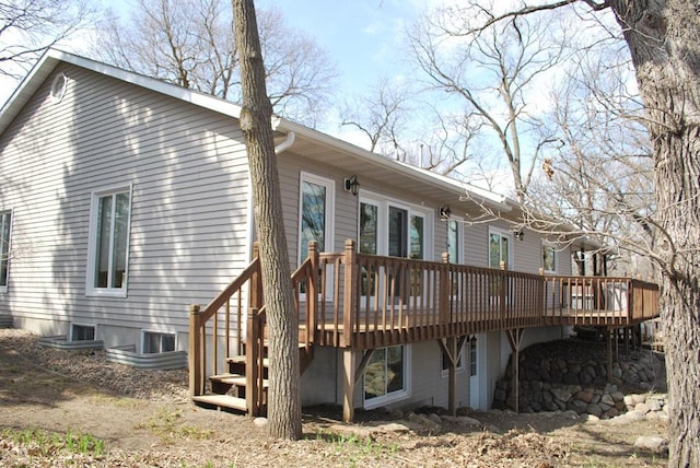 back of house with a deck