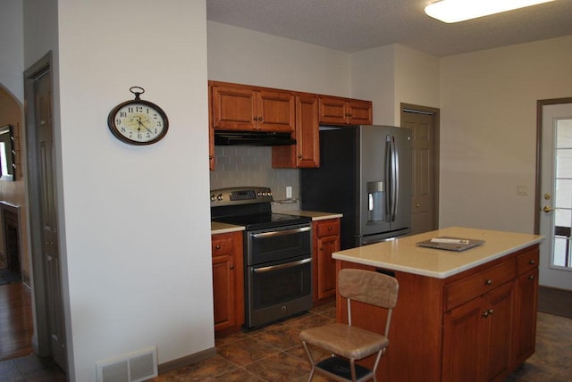 kitchen with tasteful backsplash, a center island, stainless steel appliances, dark tile floors, and range hood