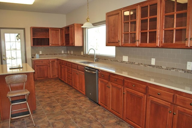 kitchen featuring sink, dark tile flooring, hanging light fixtures, stainless steel dishwasher, and tasteful backsplash