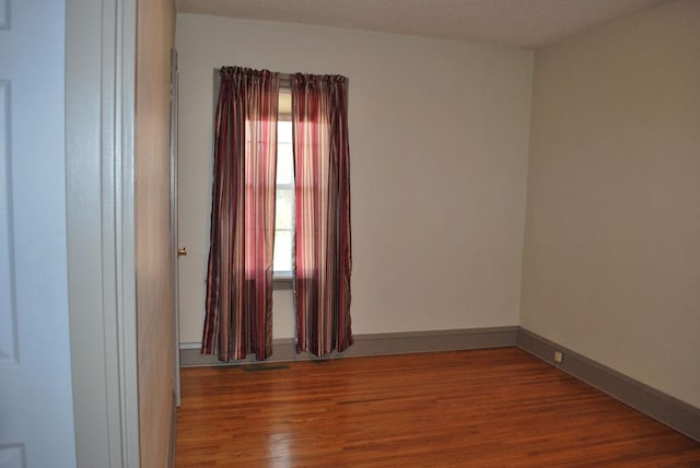 unfurnished room featuring dark hardwood / wood-style flooring