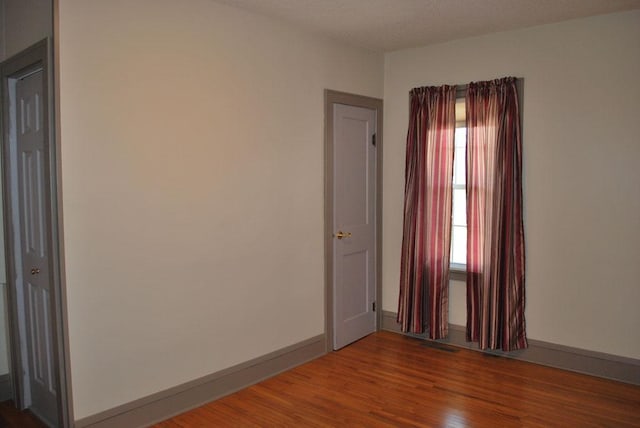 spare room featuring dark hardwood / wood-style flooring