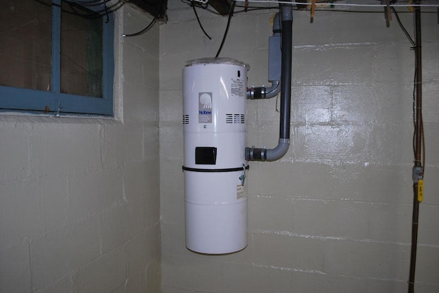 utility room featuring water heater