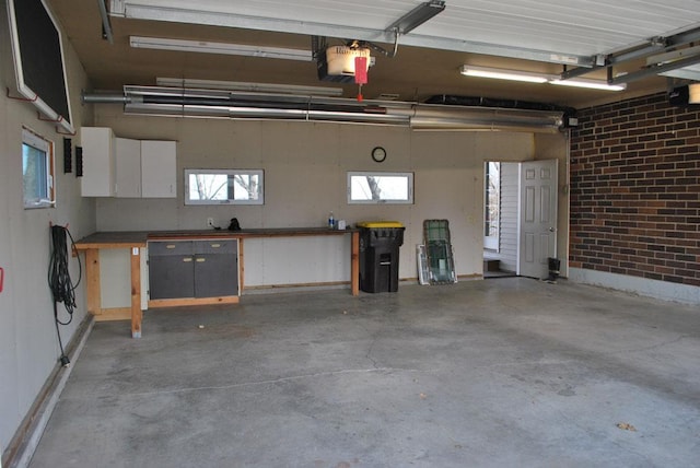 garage featuring a garage door opener and a workshop area