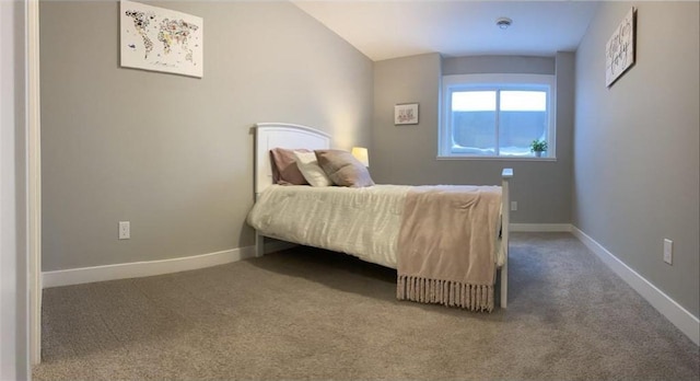 bedroom featuring carpet and baseboards