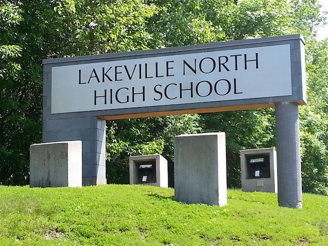 community sign featuring a lawn