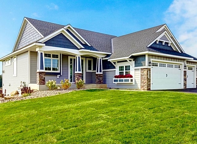 craftsman inspired home with aphalt driveway, a garage, stone siding, roof with shingles, and a front yard