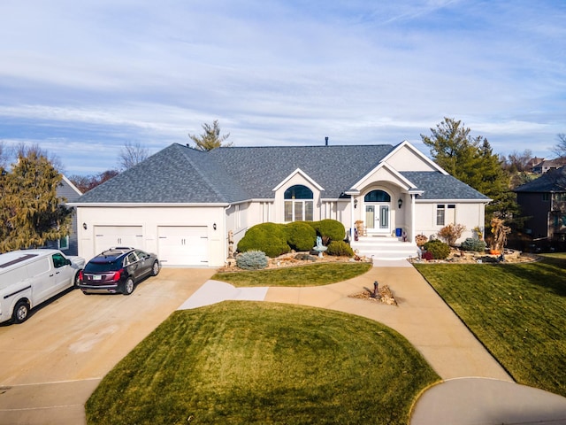 ranch-style home with french doors, a front yard, and a garage