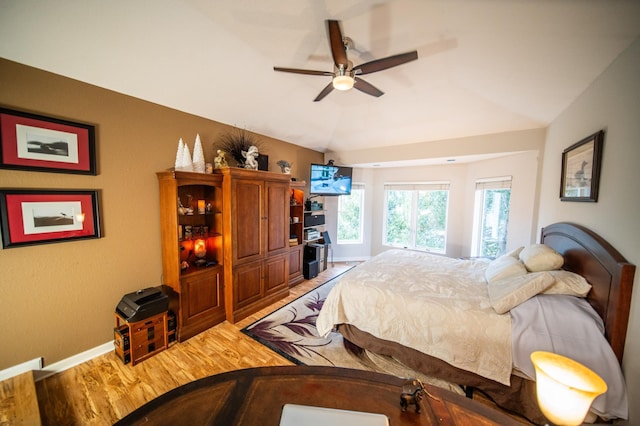 bedroom with hardwood / wood-style floors, ceiling fan, and lofted ceiling