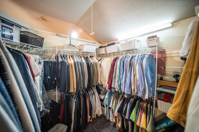 walk in closet with lofted ceiling